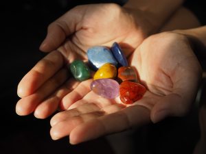 Close-up,Of,Chakra,Stones,In,Woman,Hand